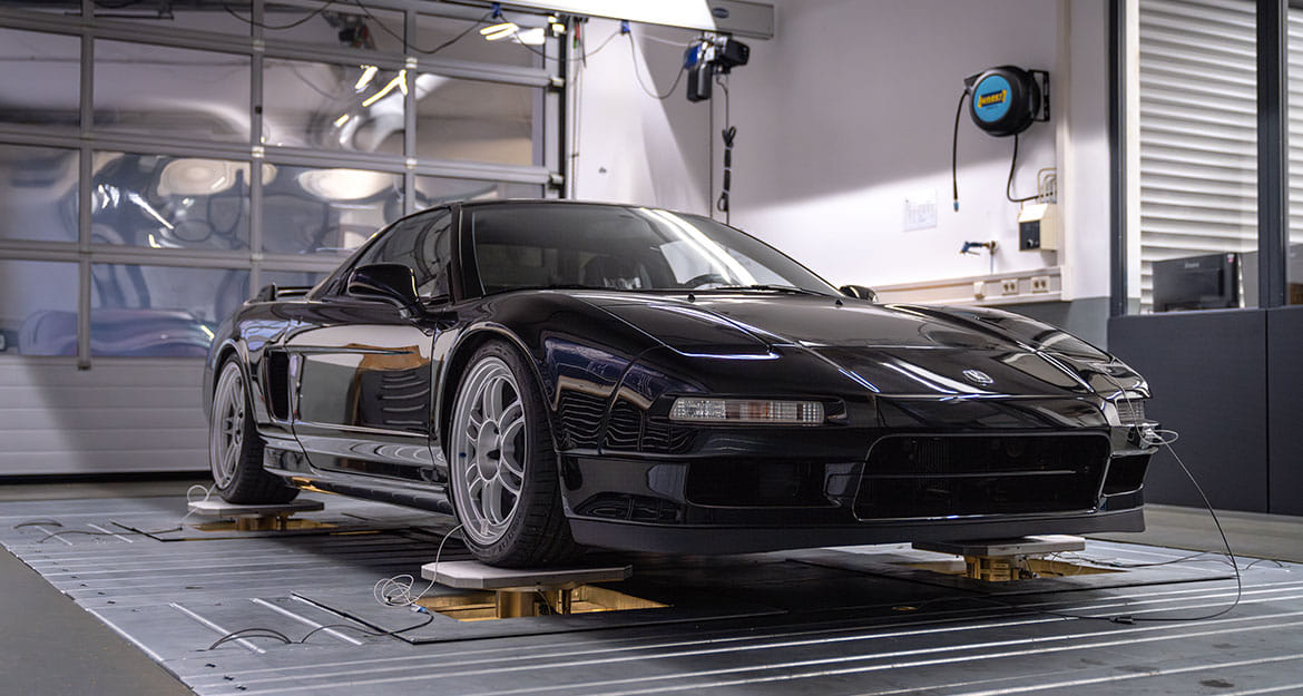 Front view of a black, lowered Honda NSX NA1 on the KW driving dynamics test bench